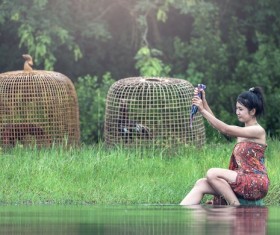 Southeast Asia girl washing clothes in the river Stock Photo