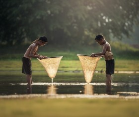 Southeast Asian children who catch fish in small rivers Stock Photo