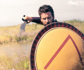 Spartan man holding a shield with knife Stock Photo