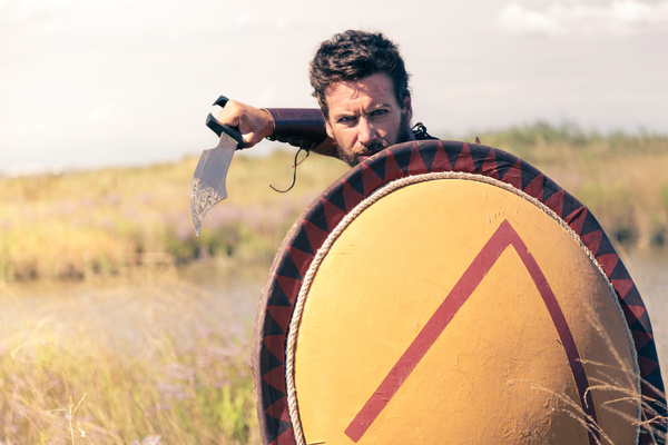 Spartan man holding a shield with knife Stock Photo