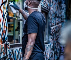 Stylish black man painting art wall Stock Photo