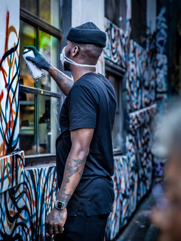 Stylish black man painting art wall Stock Photo