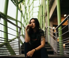 The girl sitting on the steps Stock Photo