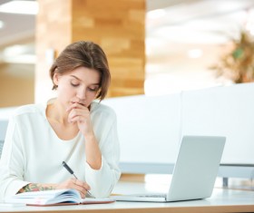 Thinking woman writing record Stock Photo