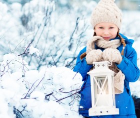 Winter outdoor little girl holding a lantern Stock Photo