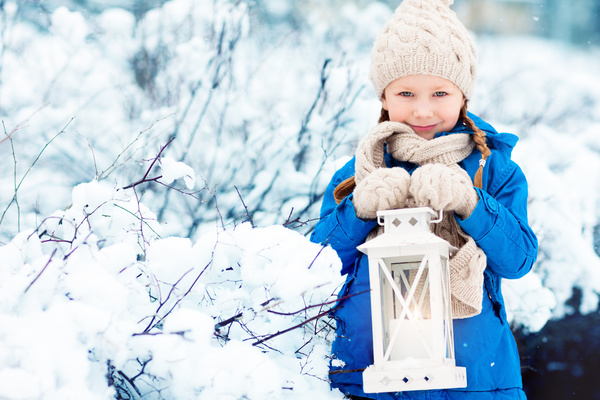 Winter outdoor little girl holding a lantern Stock Photo