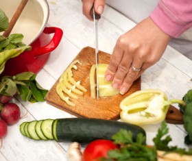 Woman chopping vegetables in the kitchen Stock Photo 01