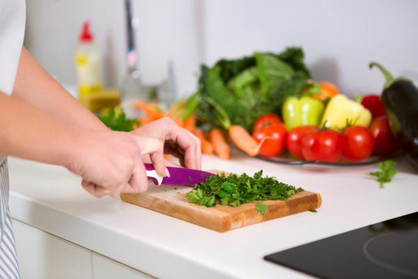Woman chopping vegetables in the kitchen Stock Photo 02