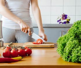 Woman chopping vegetables in the kitchen Stock Photo 03