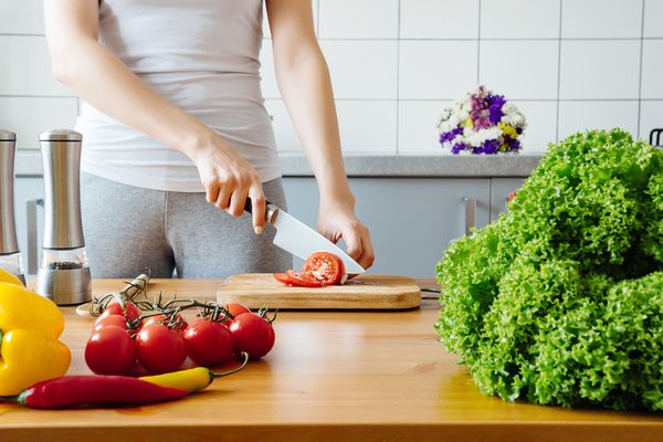 Woman chopping vegetables in the kitchen Stock Photo 03