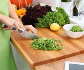 Woman cutting vegetables Stock Photo
