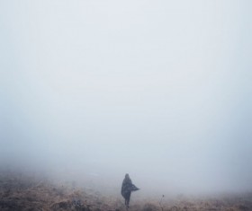 Woman in thick fog Stock Photo