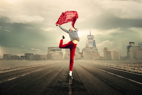 Woman jumping on the road Stock Photo