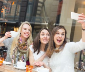 Woman taking photos with smartphone in coffee house Stock Photo 01