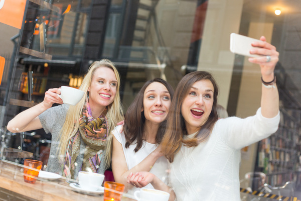 Woman taking photos with smartphone in coffee house Stock Photo 01