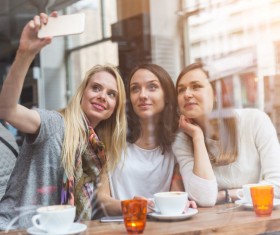 Woman taking photos with smartphone in coffee house Stock Photo 02