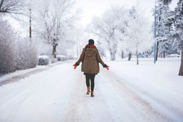 Women walking on snow covered roads Stock Photo