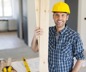 Workers holding wooden planks Stock Photo