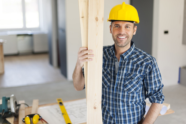 Workers holding wooden planks Stock Photo