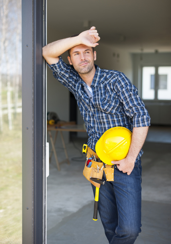 Workers leaning on the door frame to rest Stock Photo