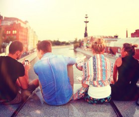 Young man sitting on the bridge Stock Photo