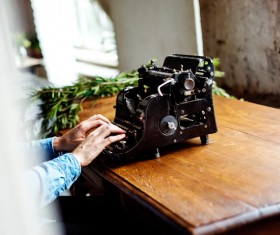 working on vintage typing machine Stock Photo