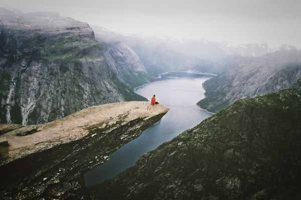 Adventurer on the edge of the cliff Stock Photo