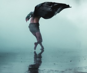 Artist man posing under rain Stock Photo