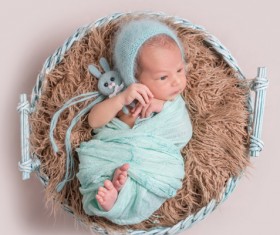 Baby lying in basket playing Stock Photo 02