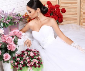 Beautiful bride in wedding dress posing among flowers Stock Photo 01