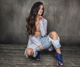 Beautiful charming fashion model squatting on the floor Stock Photo