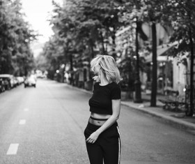 Black white photo of stylish woman on road Stock Photo