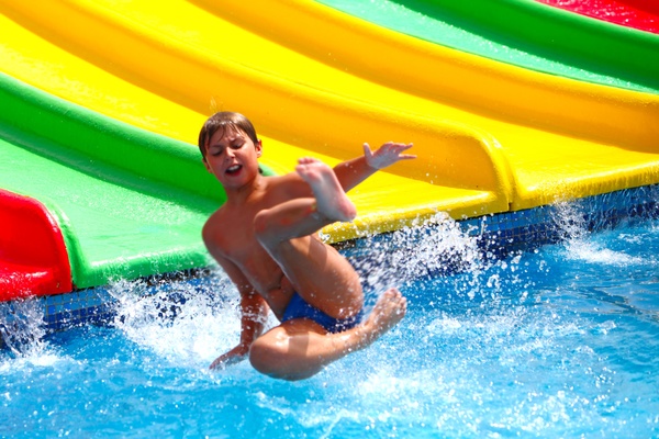 Boy in amusement park play water slides Stock Photo 01