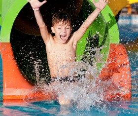 Boy in amusement park play water slides Stock Photo 02