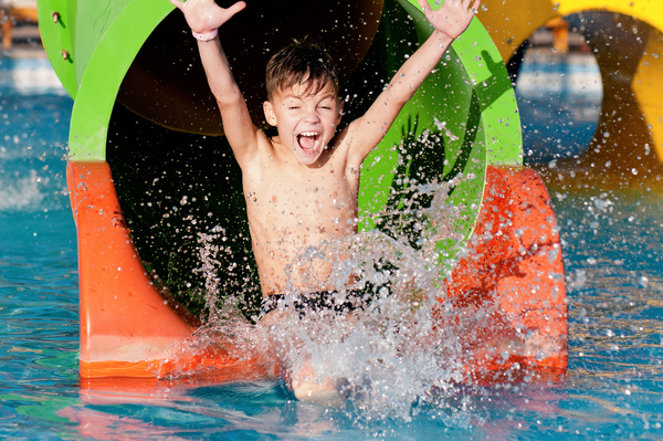 Boy in amusement park play water slides Stock Photo 02