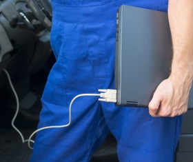 Car mechanic holding laptop Stock Photo