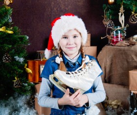 Christmas little girl holding skates Stock Photo