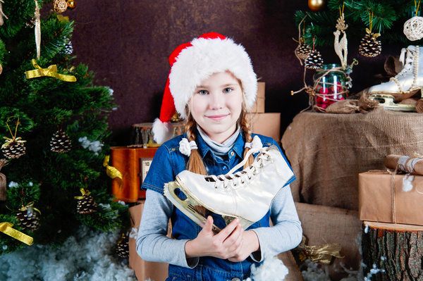 Christmas little girl holding skates Stock Photo