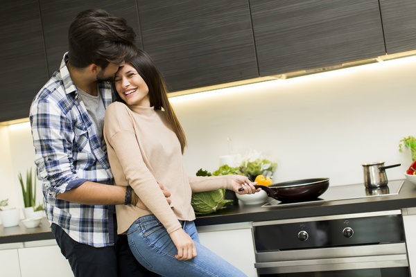 Couple hugging in the kitchen Stock Photo 02