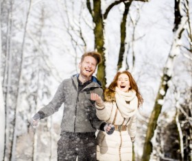 Couple playing with snow outdoor in winter Stock Photo 01