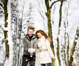 Couple playing with snow outdoor in winter Stock Photo 02
