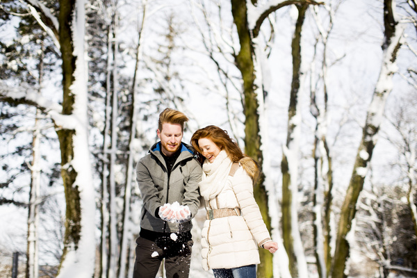 Couple playing with snow outdoor in winter Stock Photo 02