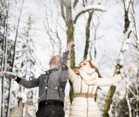 Couple playing with snow outdoor in winter Stock Photo 03