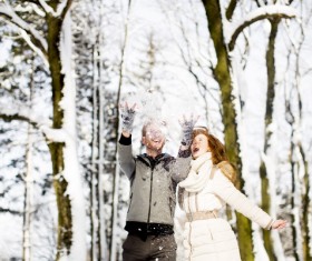 Couple playing with snow outdoor in winter Stock Photo 04
