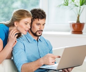 Couple using laptop Stock Photo