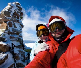 Couple using smartphone for selfie in winter Stock Photo