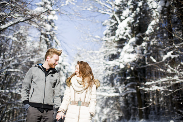 Couple walking outdoors in winter day Stock Photo
