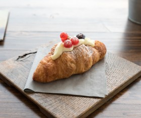Cream croissant and decorated cherry Stock Photo