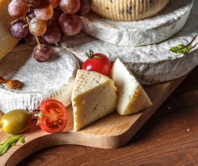 Different sorts of cheese on wooden table Stock Photo 01