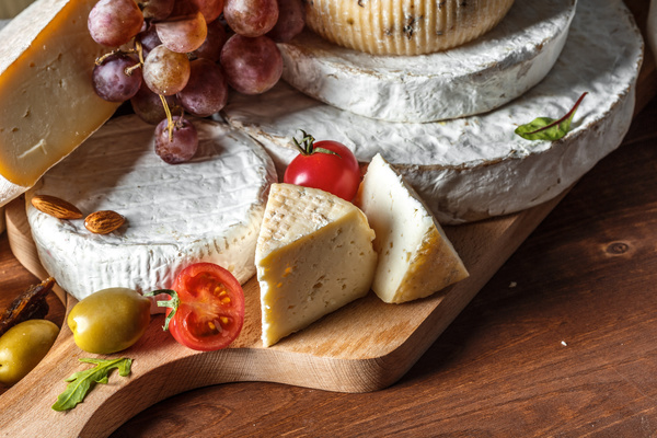 Different sorts of cheese on wooden table Stock Photo 01